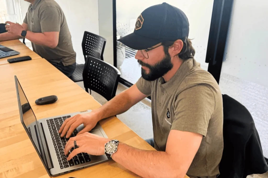 Michael working on closing a deal on his computer